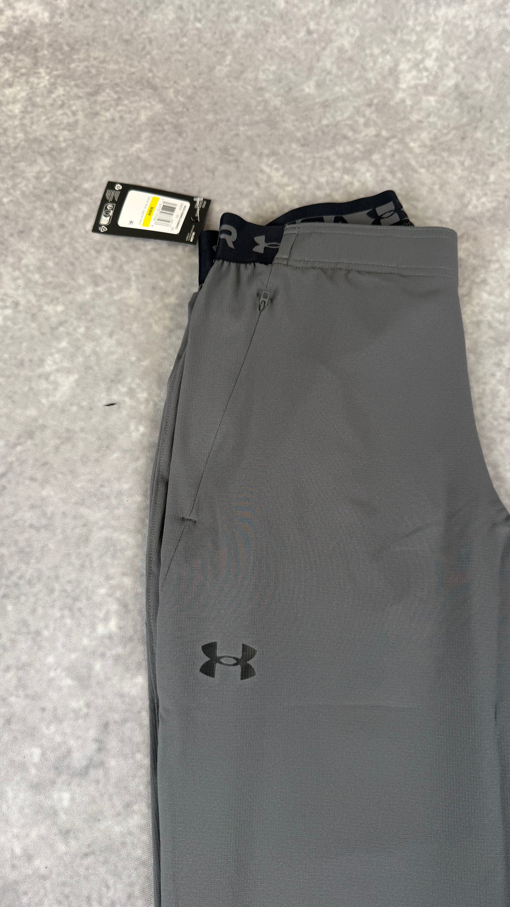 Under armour grey vanish woven tapered pants.
