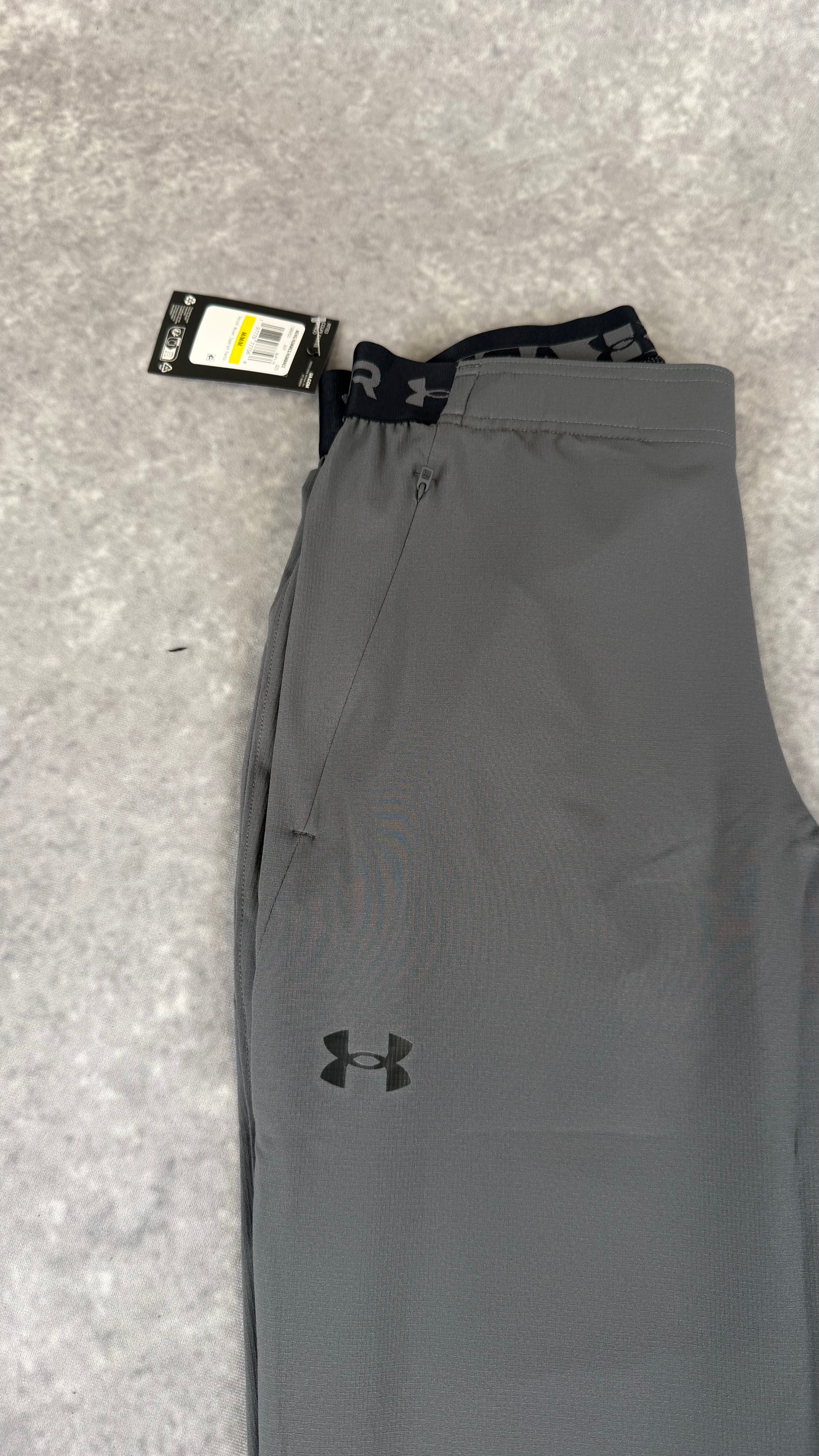 Under armour grey vanish woven tapered pants.